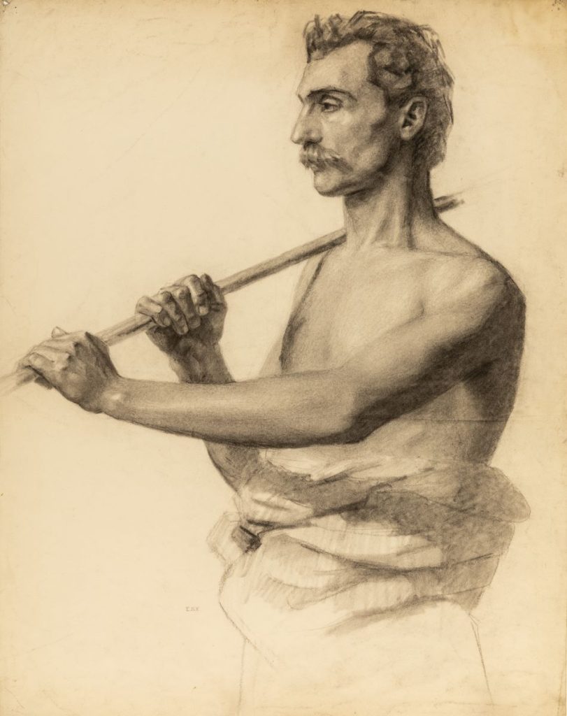 An adult male draped round the waist with an exposed torso, holding a staff over his right shoulder with both hands, the left in front of the right. The model has short hair and a wears a moustache.
